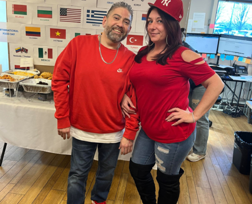 2 staff members posing for a photo during the International Food Day lunch.