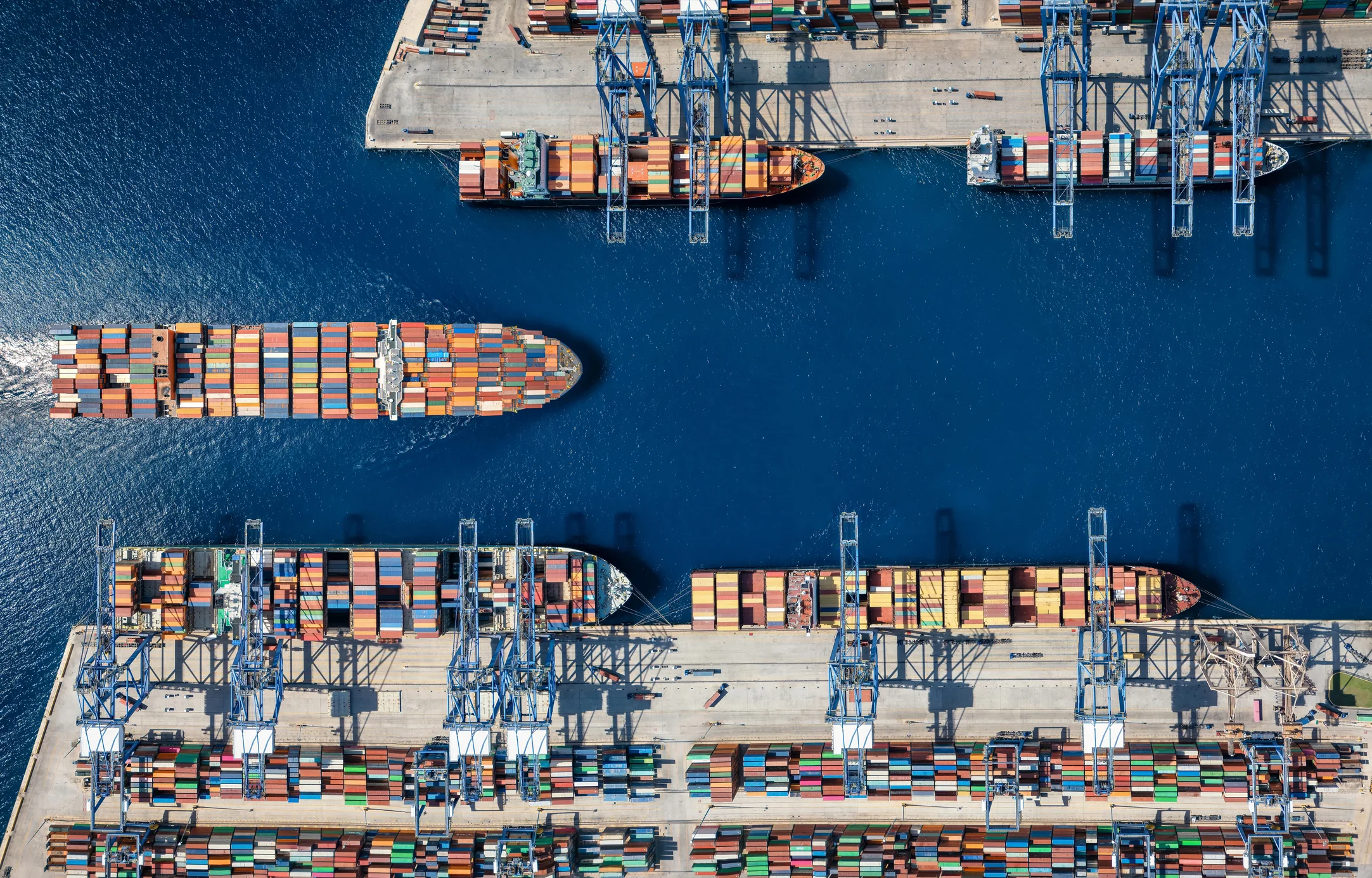 Aerial top down view of a large container cargo ship terminal harbor